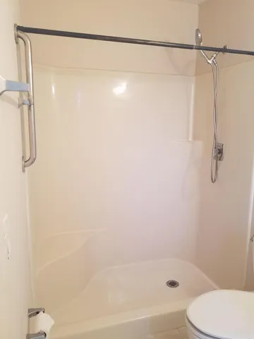 a bathroom with a toilet sink vanity and mirror