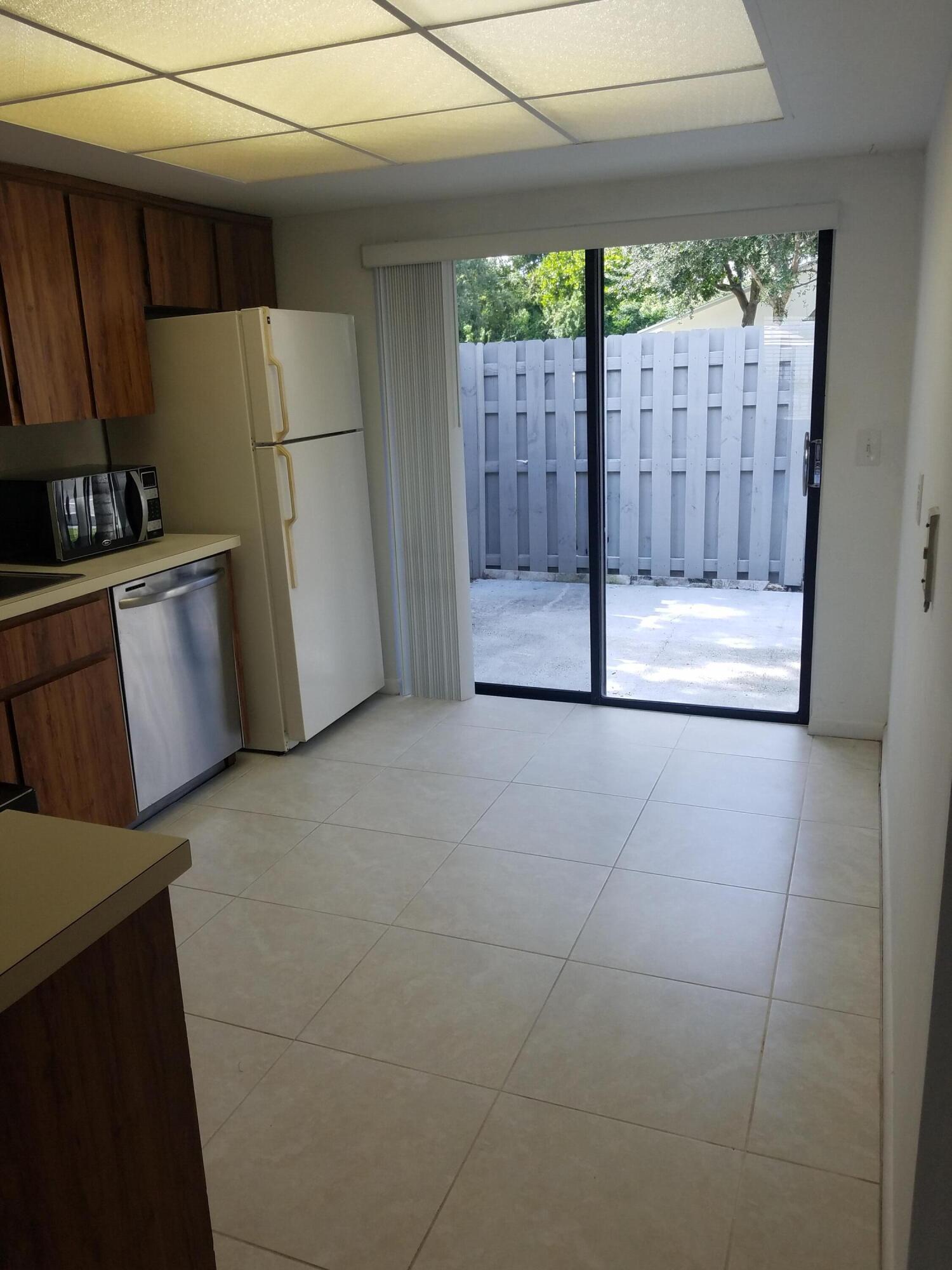 431 Jupiter Lakes Boulevard, Unit 2104B Jupiter, FL 33458 - Photo 14 of 15 Kitchen -patio