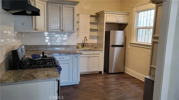 a kitchen with a refrigerator stove and cabinets