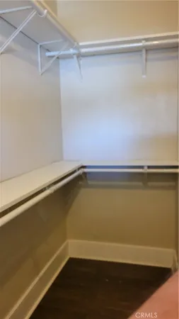 a view of a room with wooden floor and a window