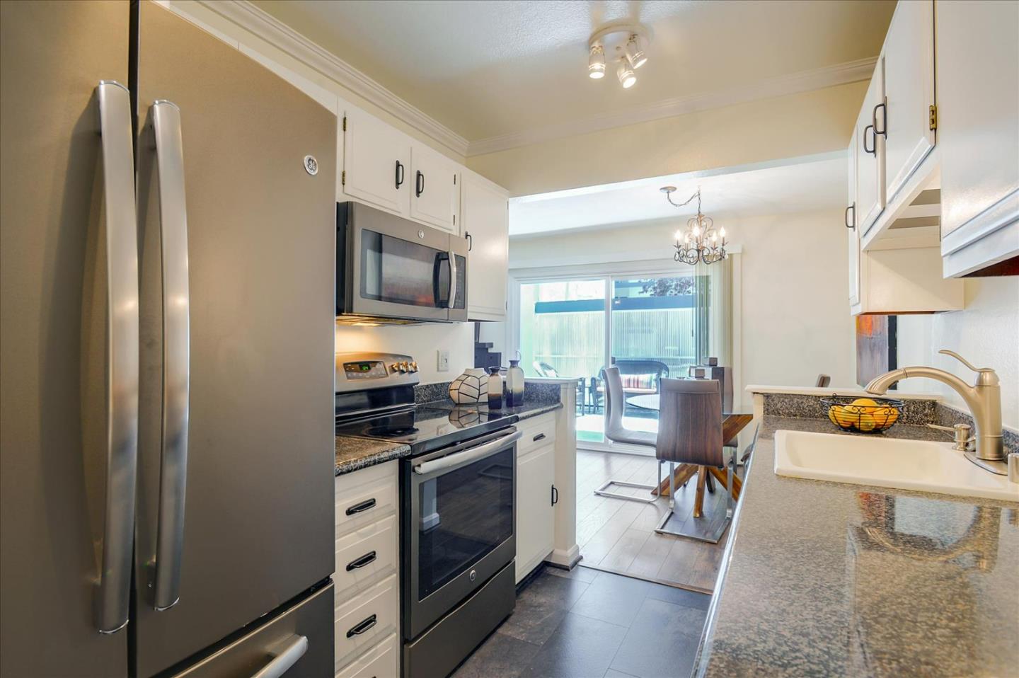 1033 Shell Boulevard, Unit 3 Foster City, CA 94404 - Photo 11 of 33 a kitchen with stainless steel appliances granite countertop a refrigerator stove and sink