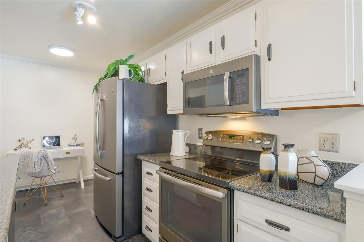 1033 Shell Boulevard, Unit 3 Foster City, CA 94404 - Photo 7 of 33 a kitchen with stainless steel appliances granite countertop a refrigerator sink and stove