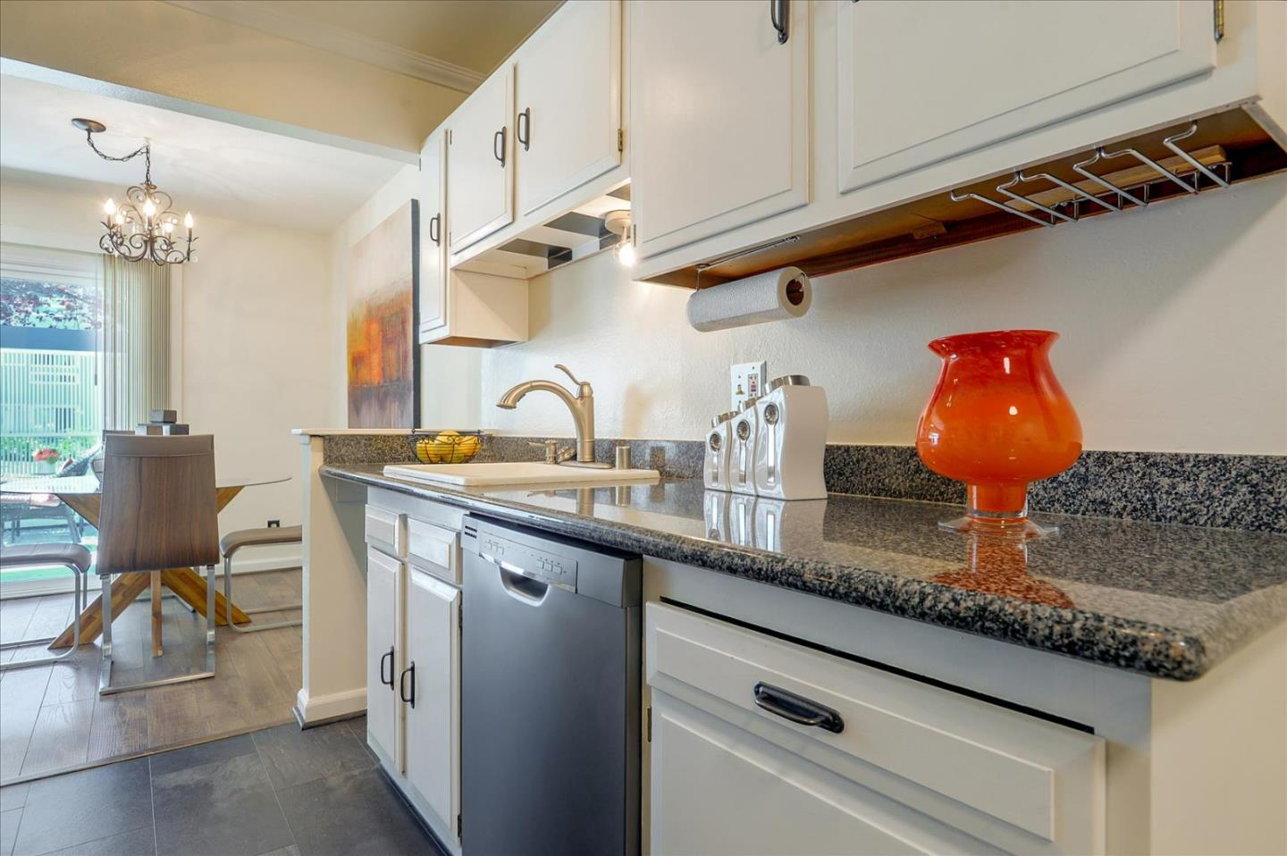 1033 Shell Boulevard, Unit 3 Foster City, CA 94404 - Photo 10 of 33 a kitchen with stainless steel appliances granite countertop a sink dishwasher and cabinets with wooden floor