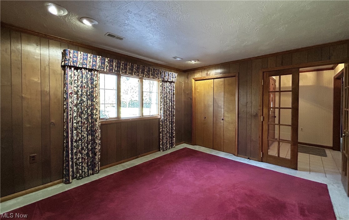7855 Mulberry Road Chesterland, OH 44026 - Photo 27 of 46 Enter this Bedroom on the first through the French Doors, accented with wood paneling and crown molding. Could also be a Den or Guest Suite.