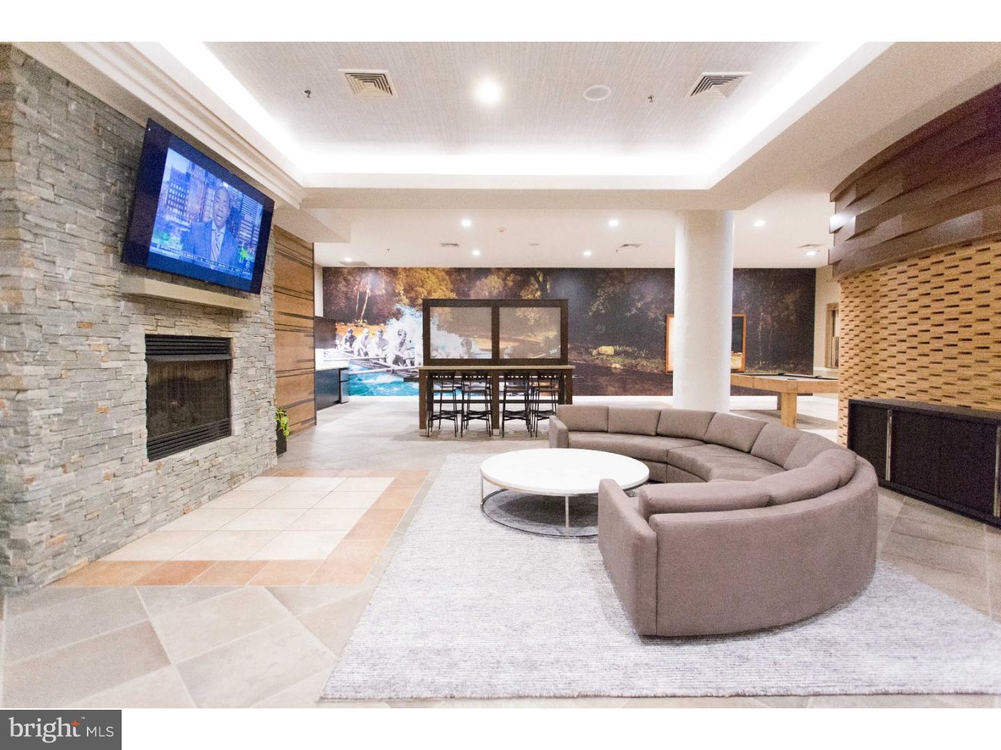 811-1 Filbert Street, Unit 503 Philadelphia, PA 19107 - Photo 4 of 18 a living room with furniture and a fireplace