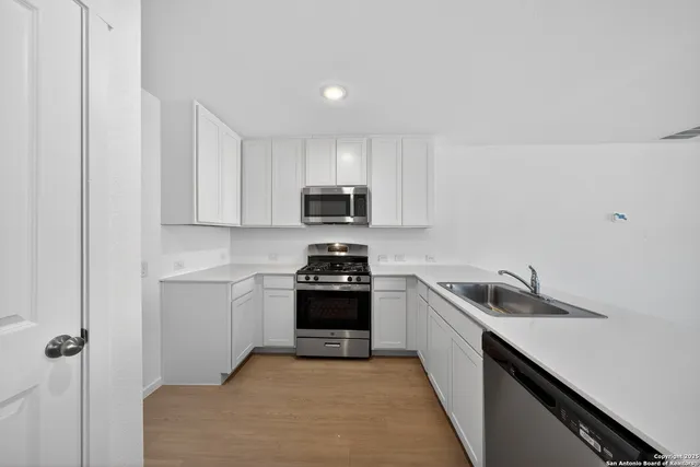 a kitchen with a sink and appliances