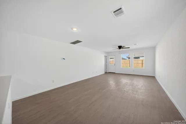 an empty room with a empty space and windows