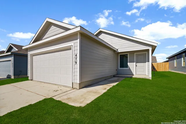 a view of backyard of house with a yard