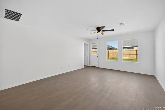 wooden floor in an empty room with a window