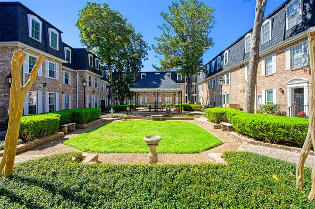 a view of a brick building next to a yard