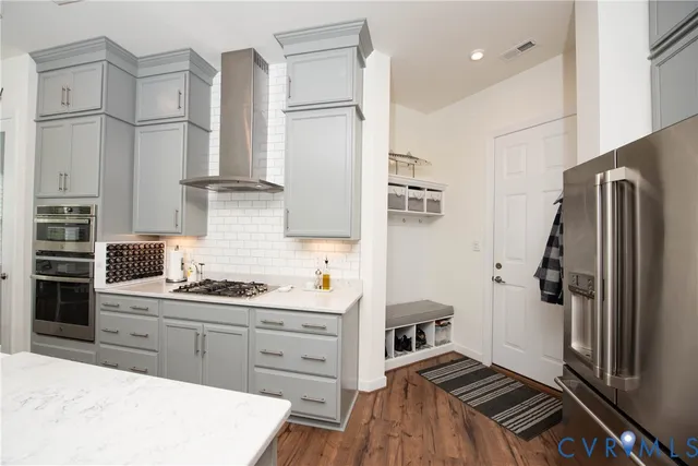 a kitchen with stainless steel appliances a refrigerator sink and cabinets