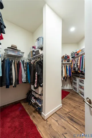 a view of walk in closet with clothes and shoes
