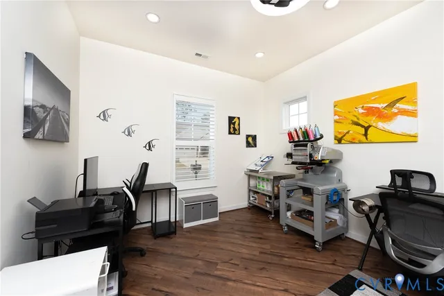 a view of a workspace with furniture and a flat screen tv