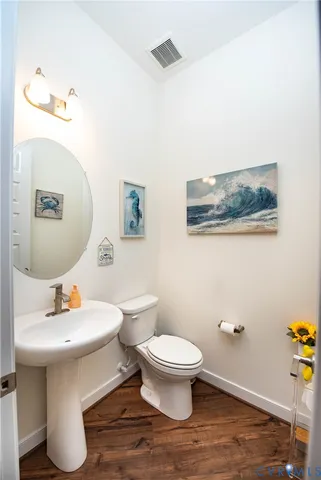 a bathroom with a sink toilet and a mirror