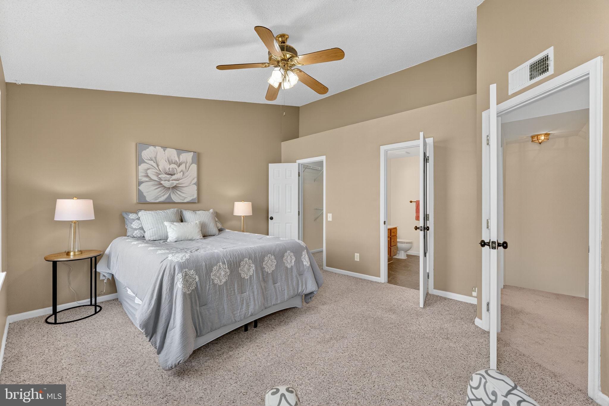 8210 Winstead Place Manassas, VA 20109 - Photo 12 of 27 a spacious bedroom with a bed and a ceiling fan