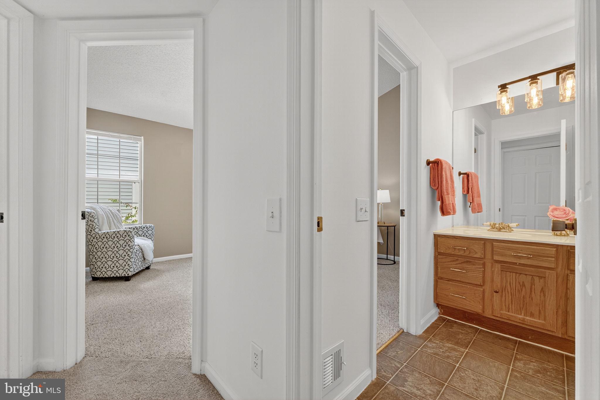8210 Winstead Place Manassas, VA 20109 - Photo 16 of 27 a en suite bathroom with a sink and a mirror