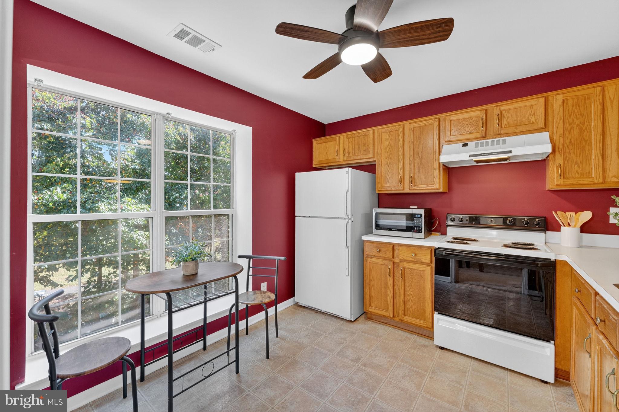 8210 Winstead Place Manassas, VA 20109 - Photo 9 of 27 a kitchen with a stove a refrigerator and furniture