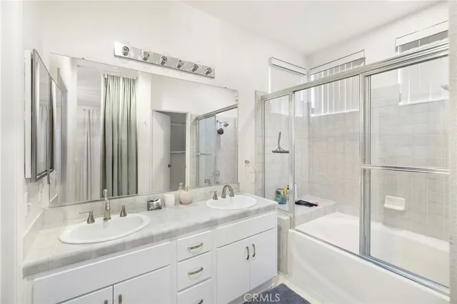 a bathroom with a sink toilet vanity and shower