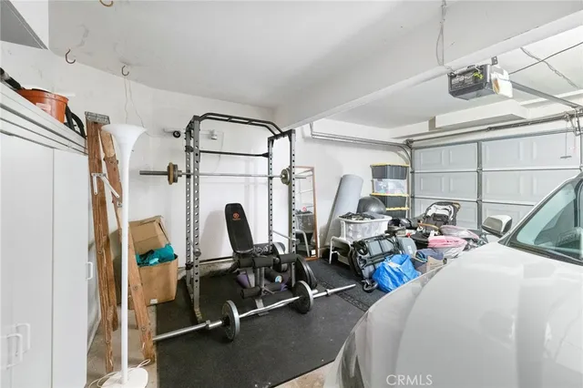 a view of a patio with table and chairs potted plants and wooden fence