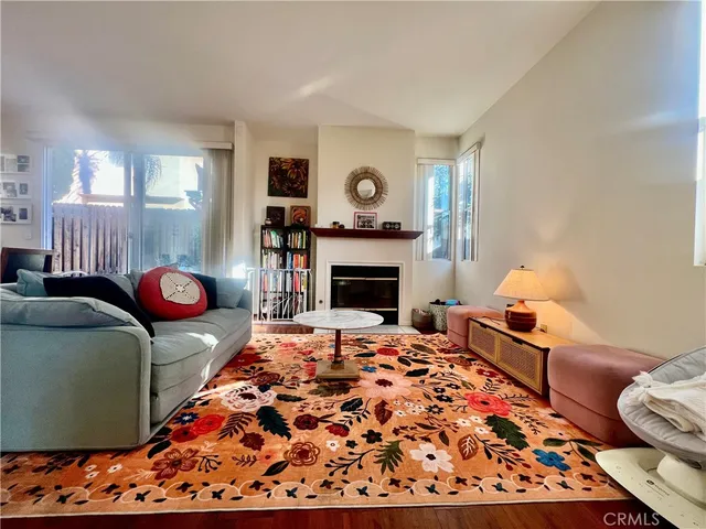 a living room with large bed and chandelier