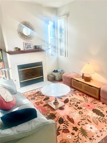 a living room with furniture a dining table and a fireplace