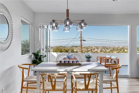 a view of a dining room with furniture and chandelier