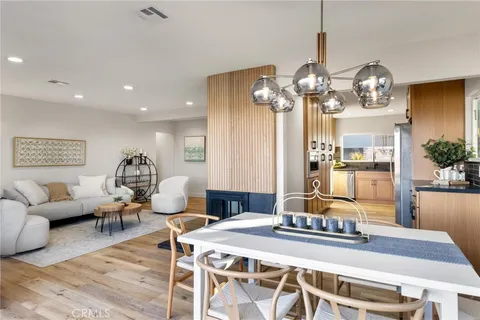 a living room with furniture a chandelier and a table