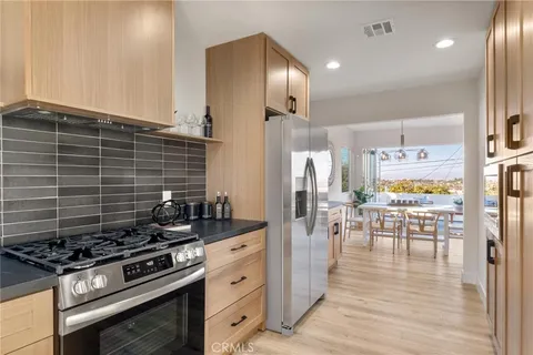 a kitchen with stainless steel appliances stove top oven and cabinets