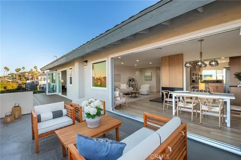 a living room with furniture kitchen view and a large window