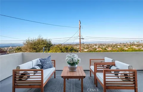 a dining room with furniture and a potted plant