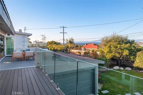 a bedroom with a large bed a chandelier and closet