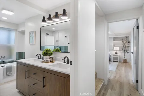 a bathroom with a double vanity sink and a mirror