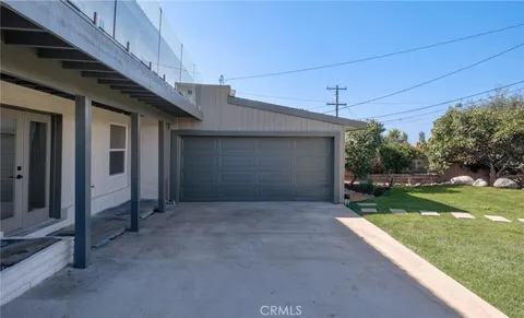 a view of a backyard with swimming pool