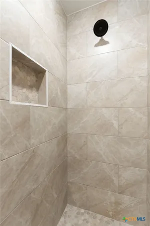 a bathroom with a granite countertop sink a light fixture and a mirror