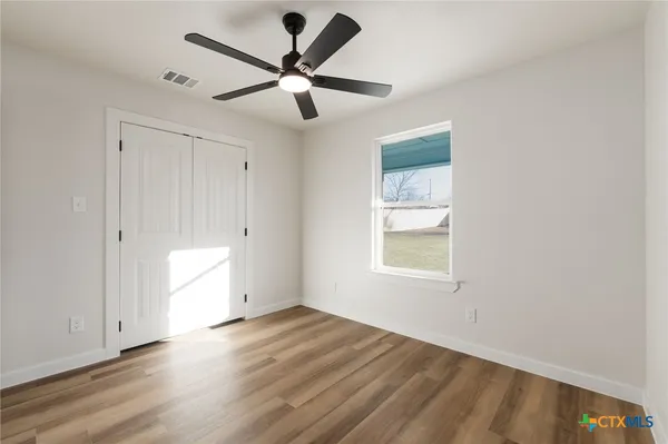 a bathroom with a granite countertop sink toilet a mirror and bathtub