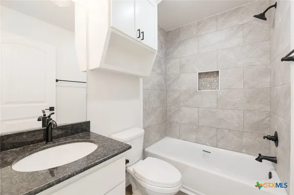 a view of storage and utility room with closet