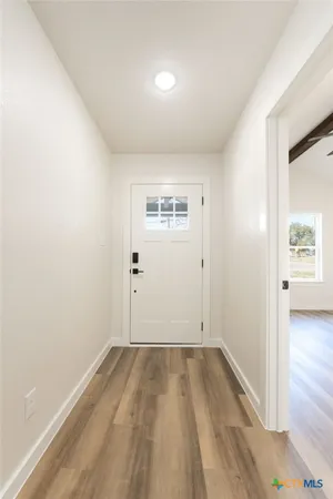 a view of a kitchen with a dishwasher and wooden floor