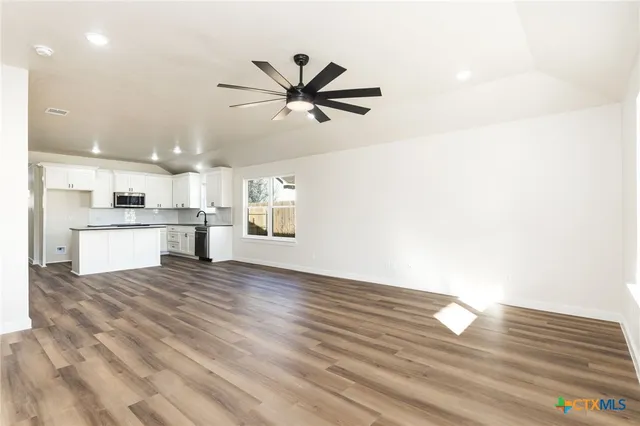 a view of a kitchen with a sink and a refrigerator