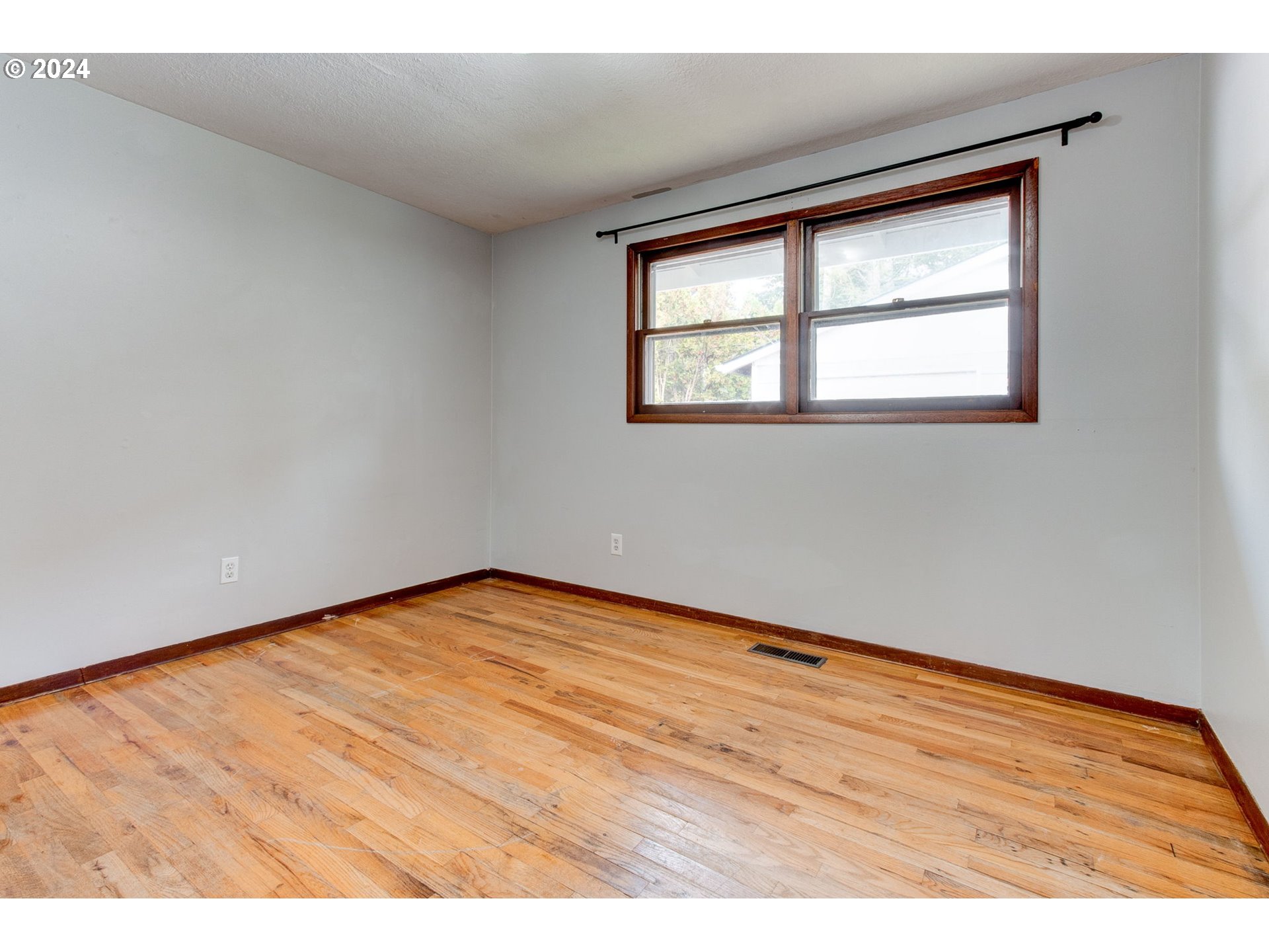 14205 Southeast Salmon Street Portland, OR 97233 - Photo 14 of 35 an empty room with wooden floor and windows