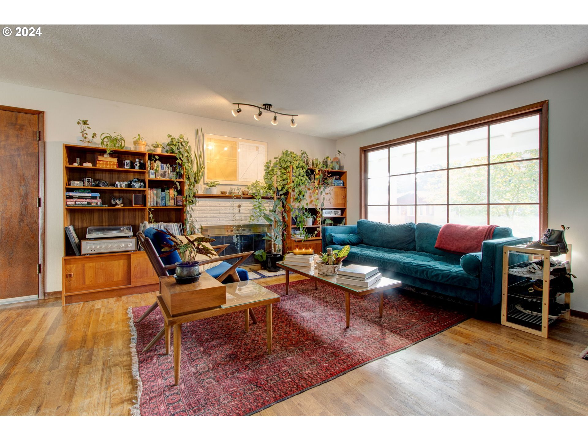 14205 Southeast Salmon Street Portland, OR 97233 - Photo 3 of 35 a living room with furniture a bookshelf and a large window