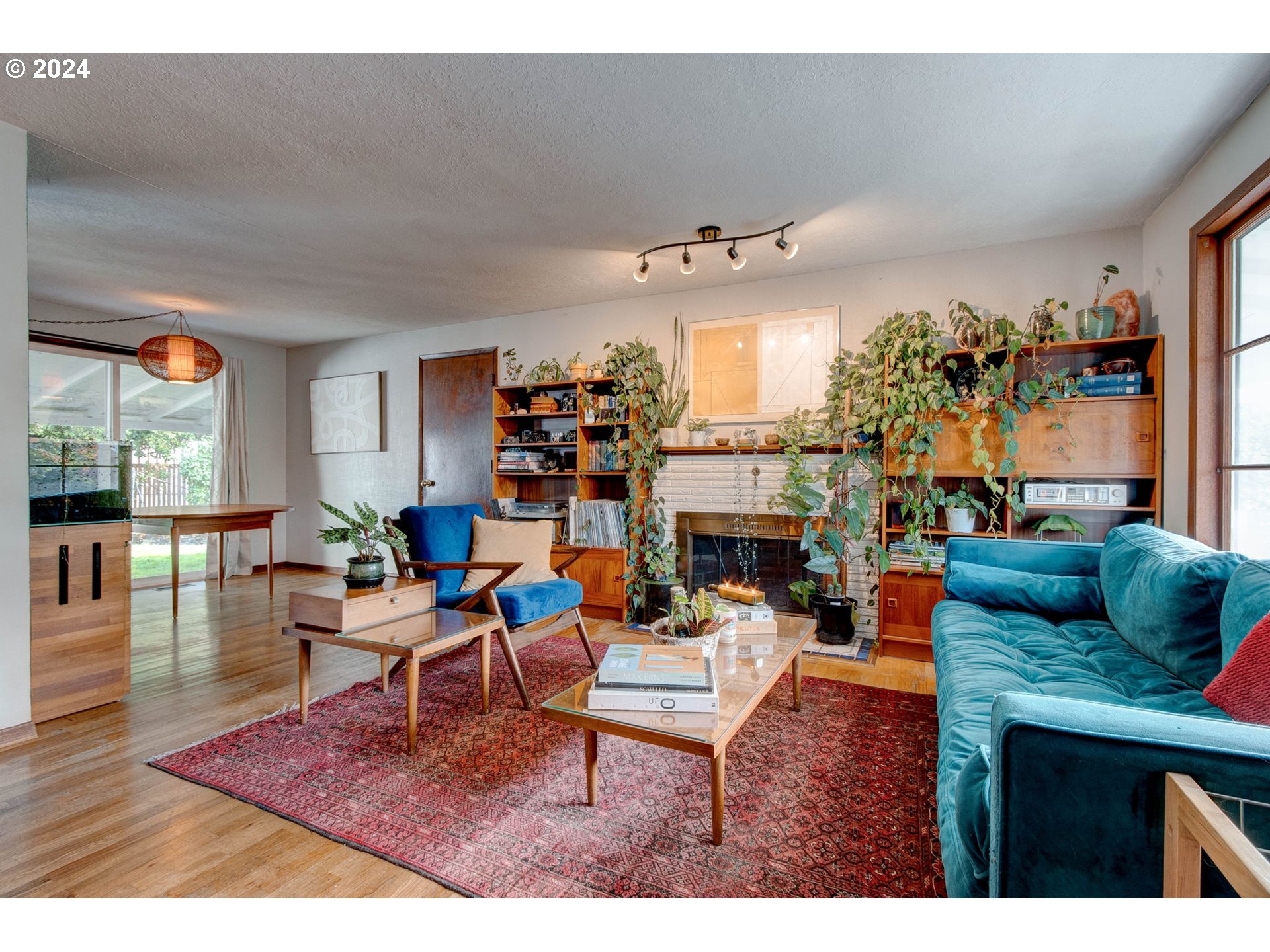 14205 Southeast Salmon Street Portland, OR 97233 - Photo 5 of 35 a living room with fireplace furniture and a large window