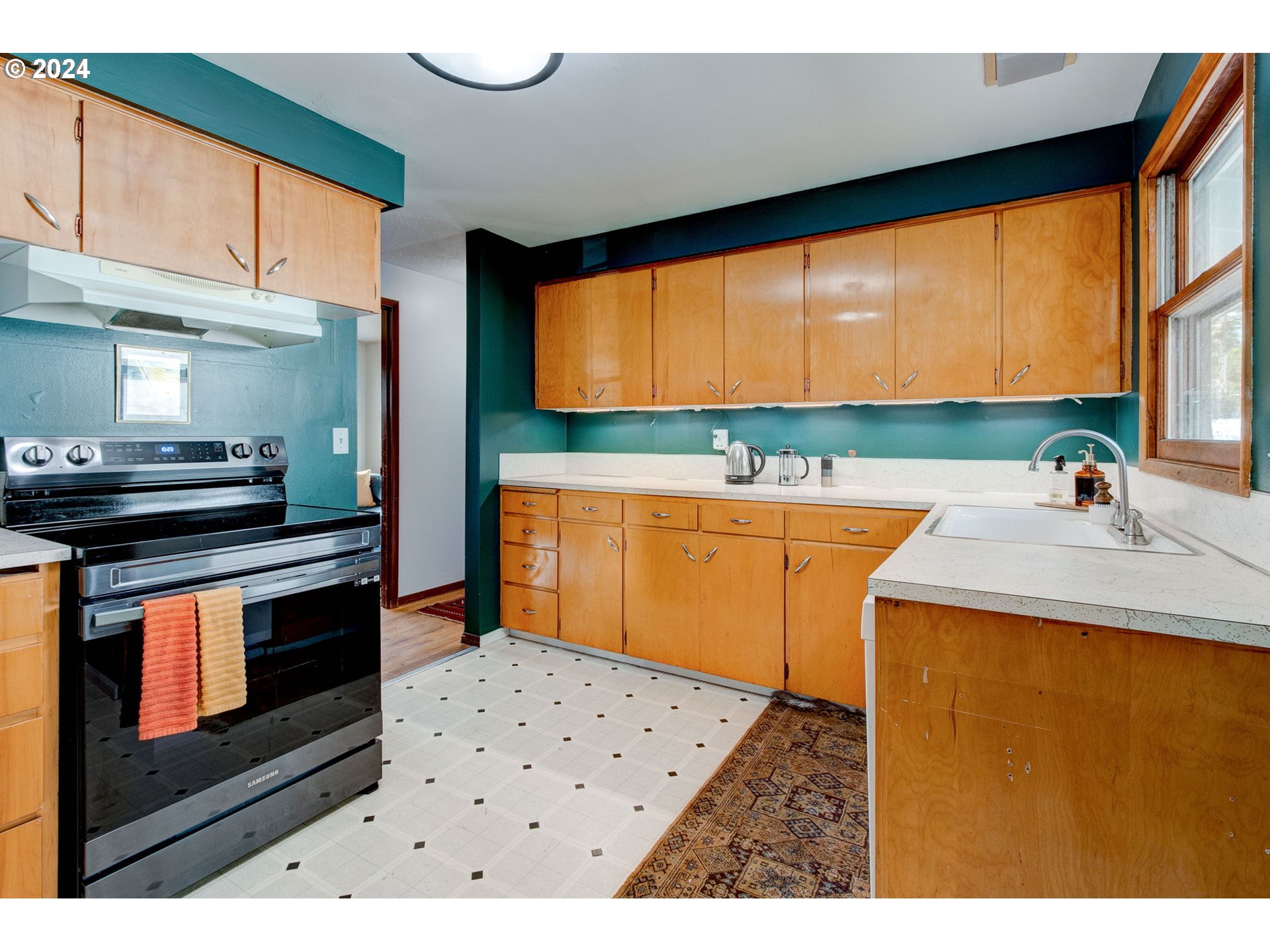 14205 Southeast Salmon Street Portland, OR 97233 - Photo 8 of 35 a kitchen with a sink cabinets and appliances