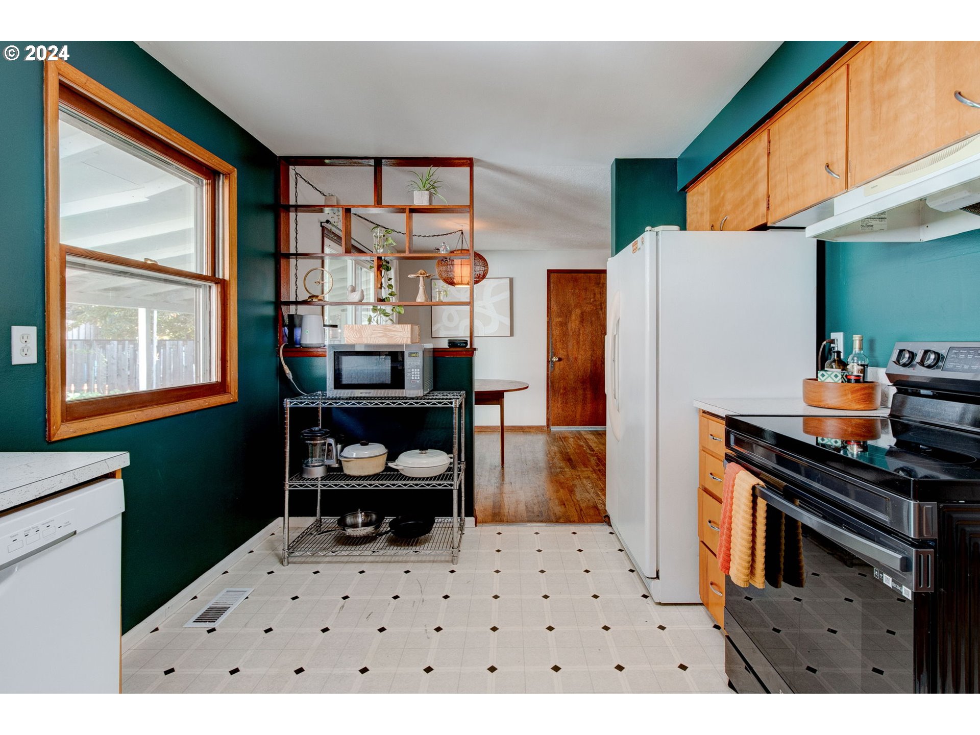 14205 Southeast Salmon Street Portland, OR 97233 - Photo 9 of 35 a kitchen with a refrigerator and a stove