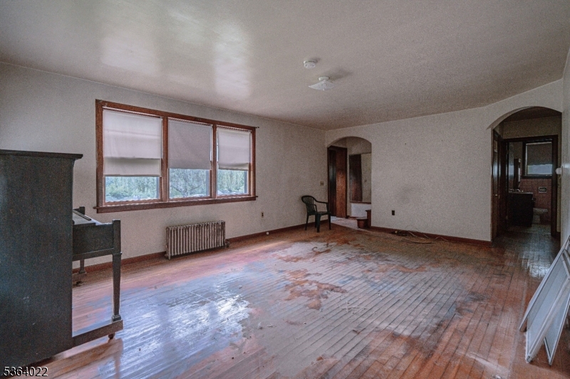 79 Mountain Lake Road Belvidere, NJ 07823 - Photo 20 of 47 a view of an empty room with a window and wooden floor