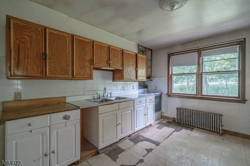79 Mountain Lake Road Belvidere, NJ 07823 - Photo 22 of 47 a kitchen with a sink stove and cabinets
