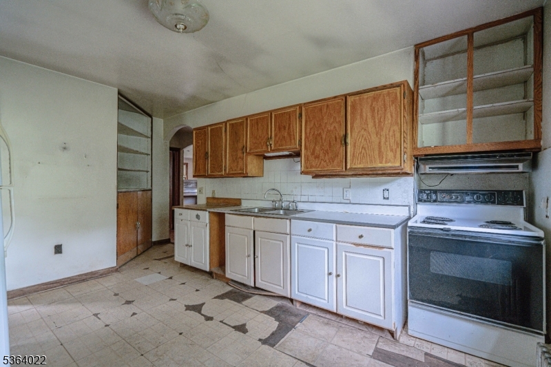 79 Mountain Lake Road Belvidere, NJ 07823 - Photo 23 of 47 a kitchen with granite countertop a stove sink and cabinets