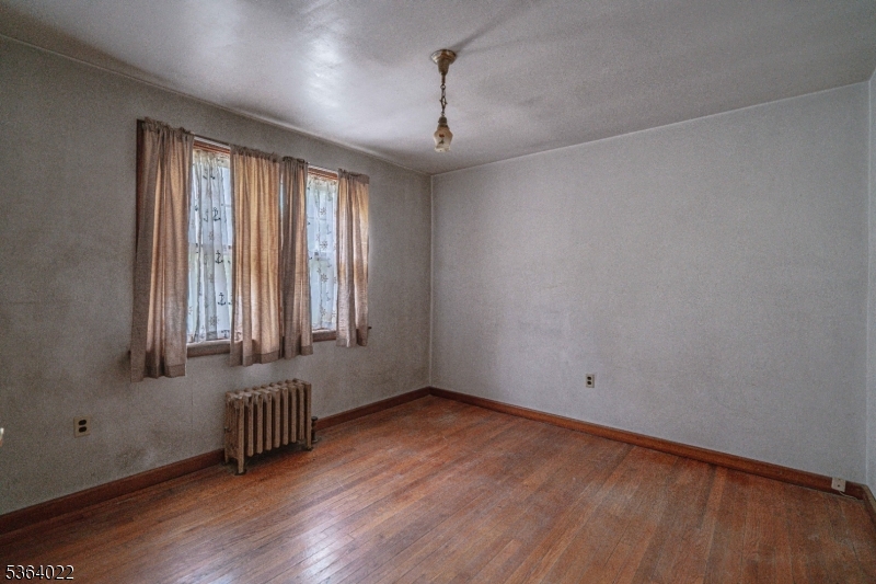 79 Mountain Lake Road Belvidere, NJ 07823 - Photo 28 of 47 an empty room with wooden floor and windows