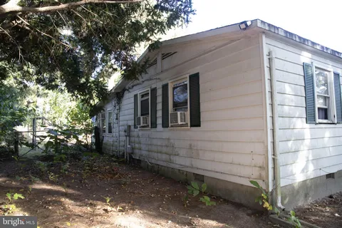 a brick house with a large tree