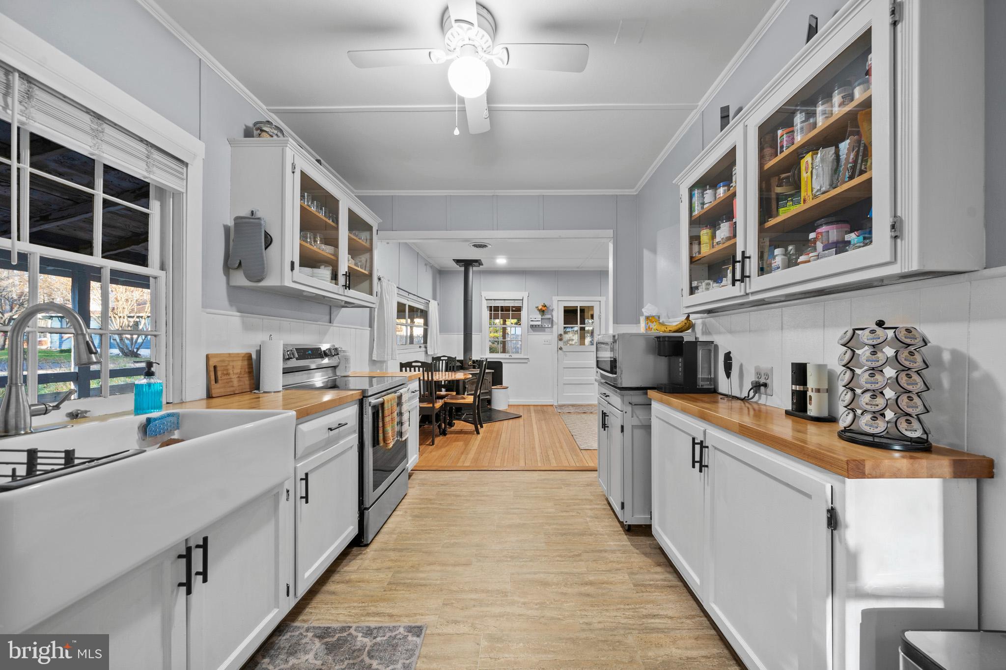 6015 Poplar Road St. Leonard, MD 20685 - Photo 21 of 35 a large white kitchen with stainless steel appliances granite countertop a stove and cabinets
