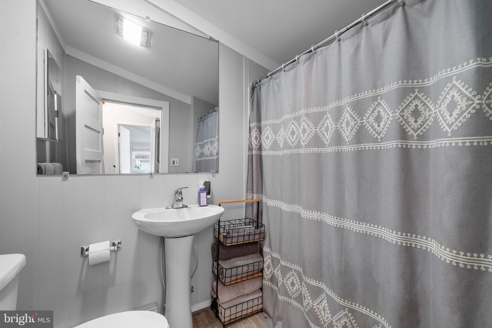 6015 Poplar Road St. Leonard, MD 20685 - Photo 23 of 35 a bathroom with a sink toilet and a mirror